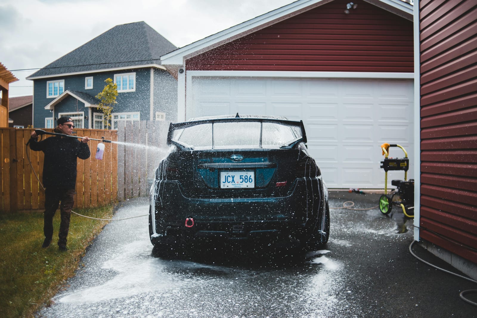 Car wash technician cleaning a vehicle