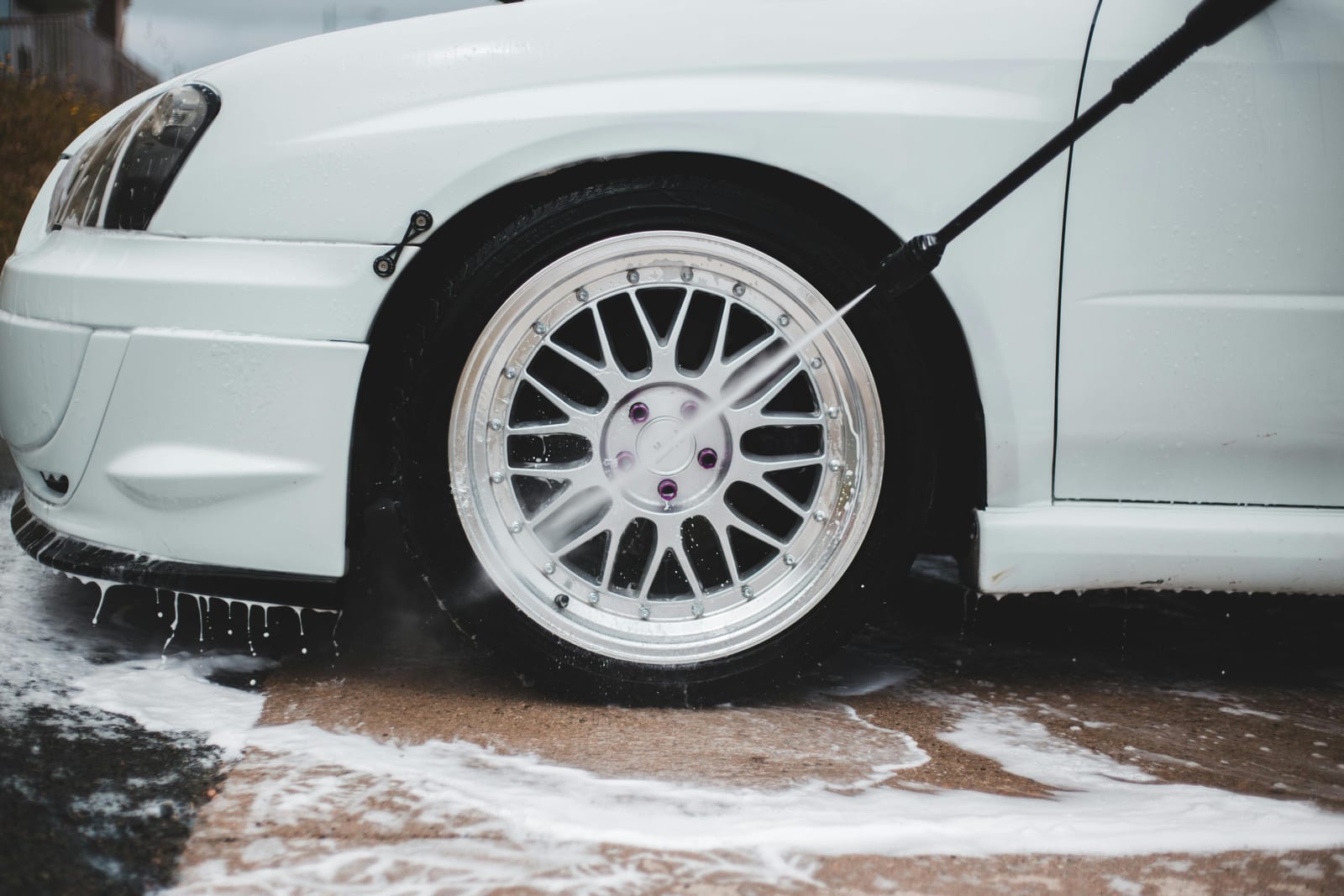 Vehicle being washed with high-pressure water